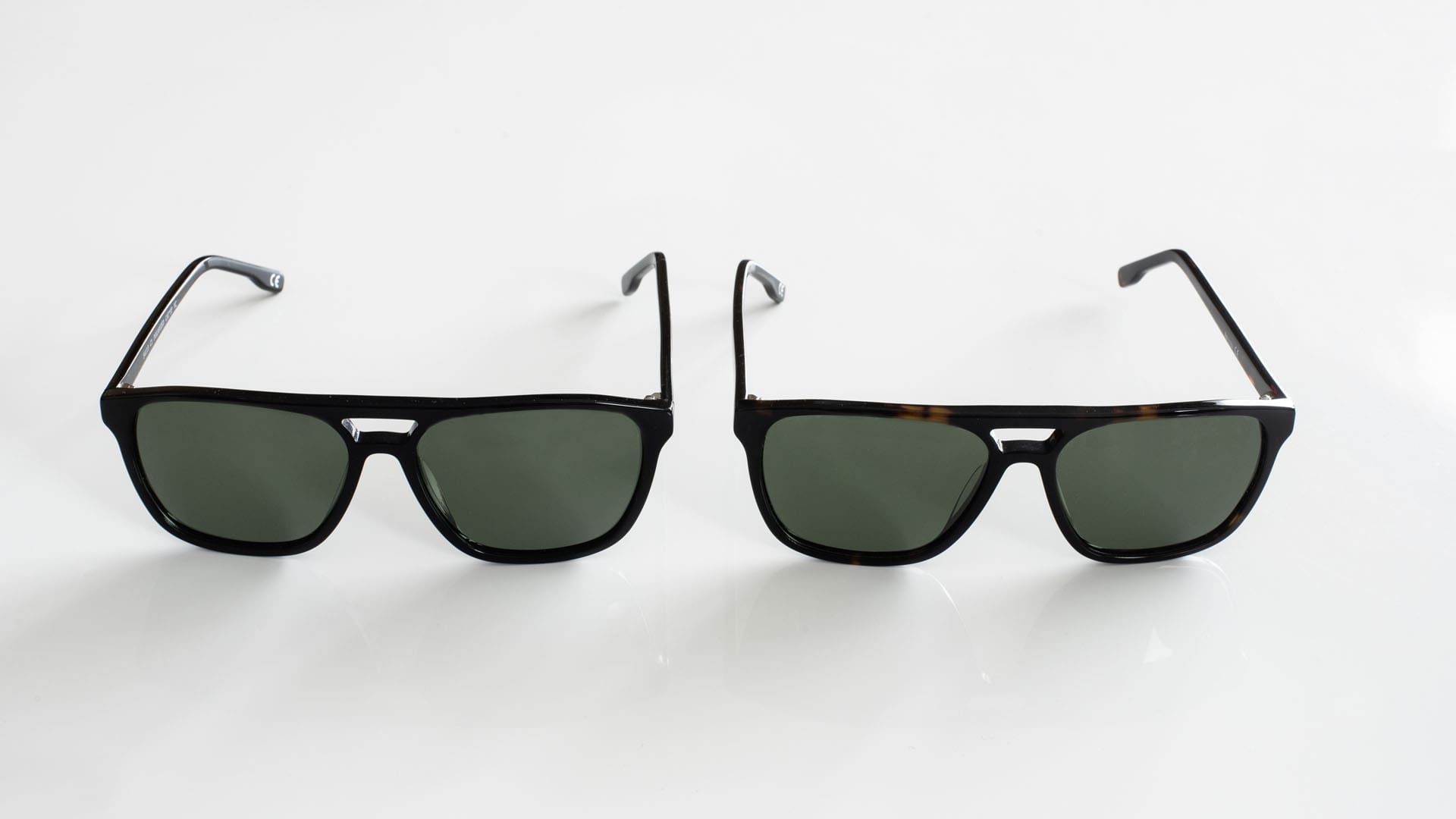 2 paires de lunettes de soleil côte à côte modèle homme noir et écaille VPH4